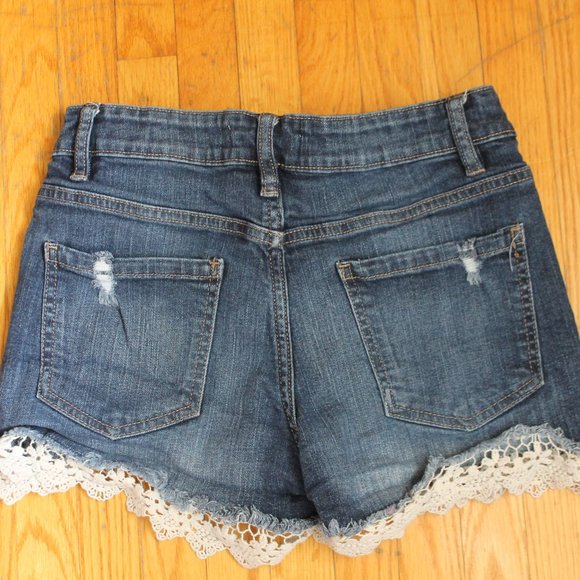 Low-rise/dark wash denim shorts with rips and white lace (Size S). - Picture 2 of 2